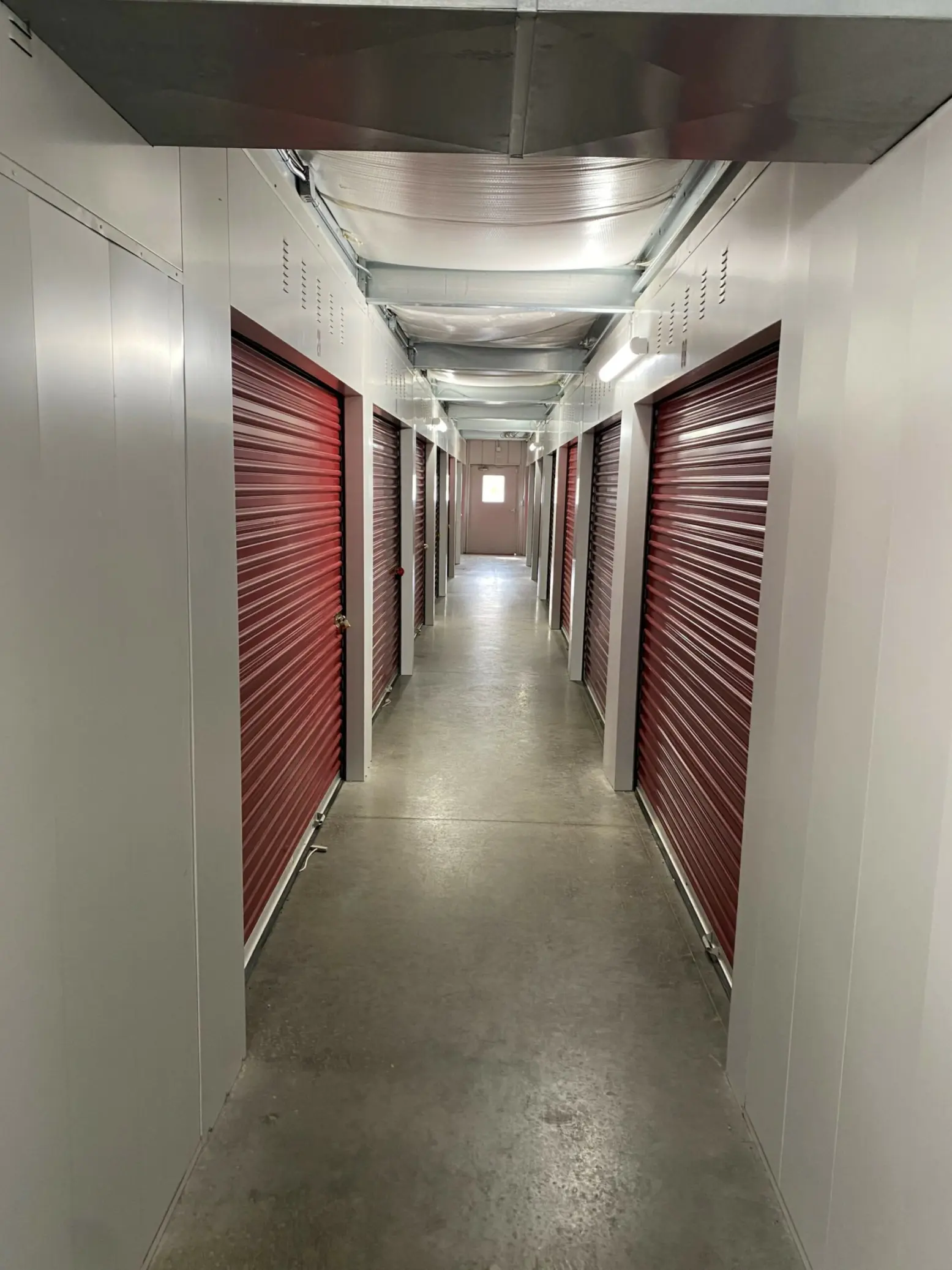 Indoor storage units with red doors.