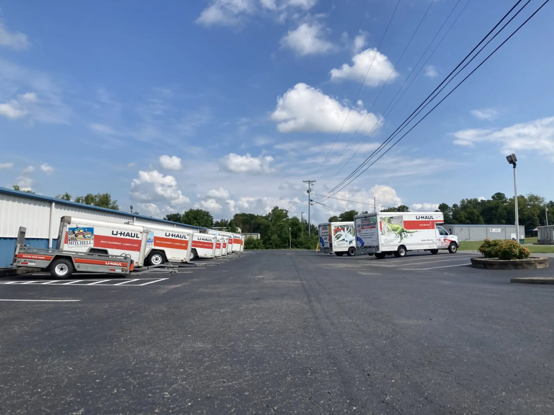 U-Haul moving trucks parking in parking lot available for rent.