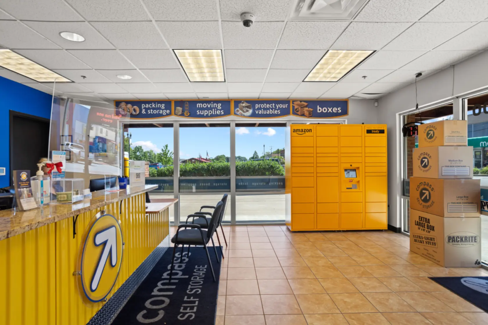 Compass Self storage office with Amazon locker and packing boxes.