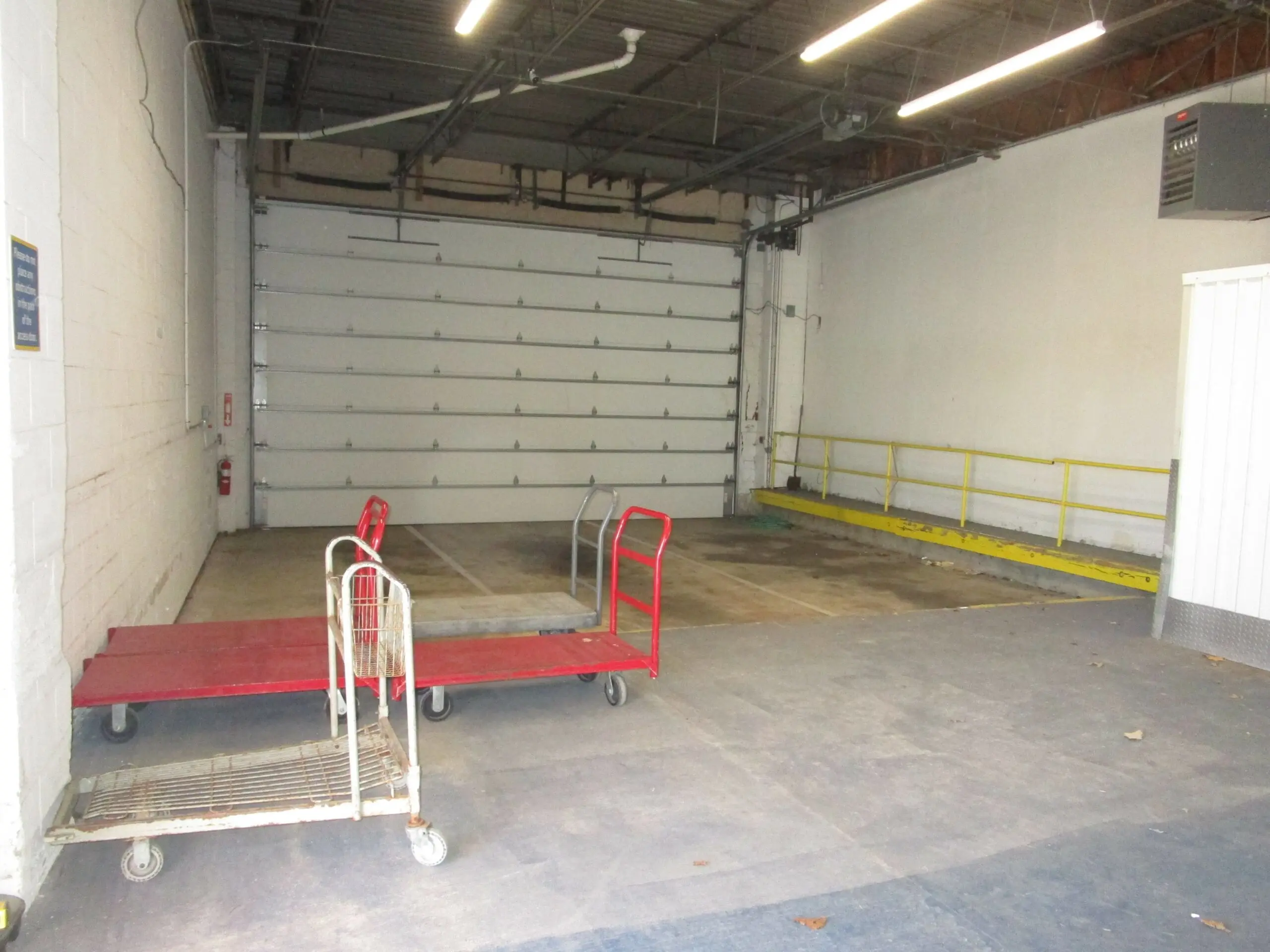 Inside view of loading dock with moving carts for use.