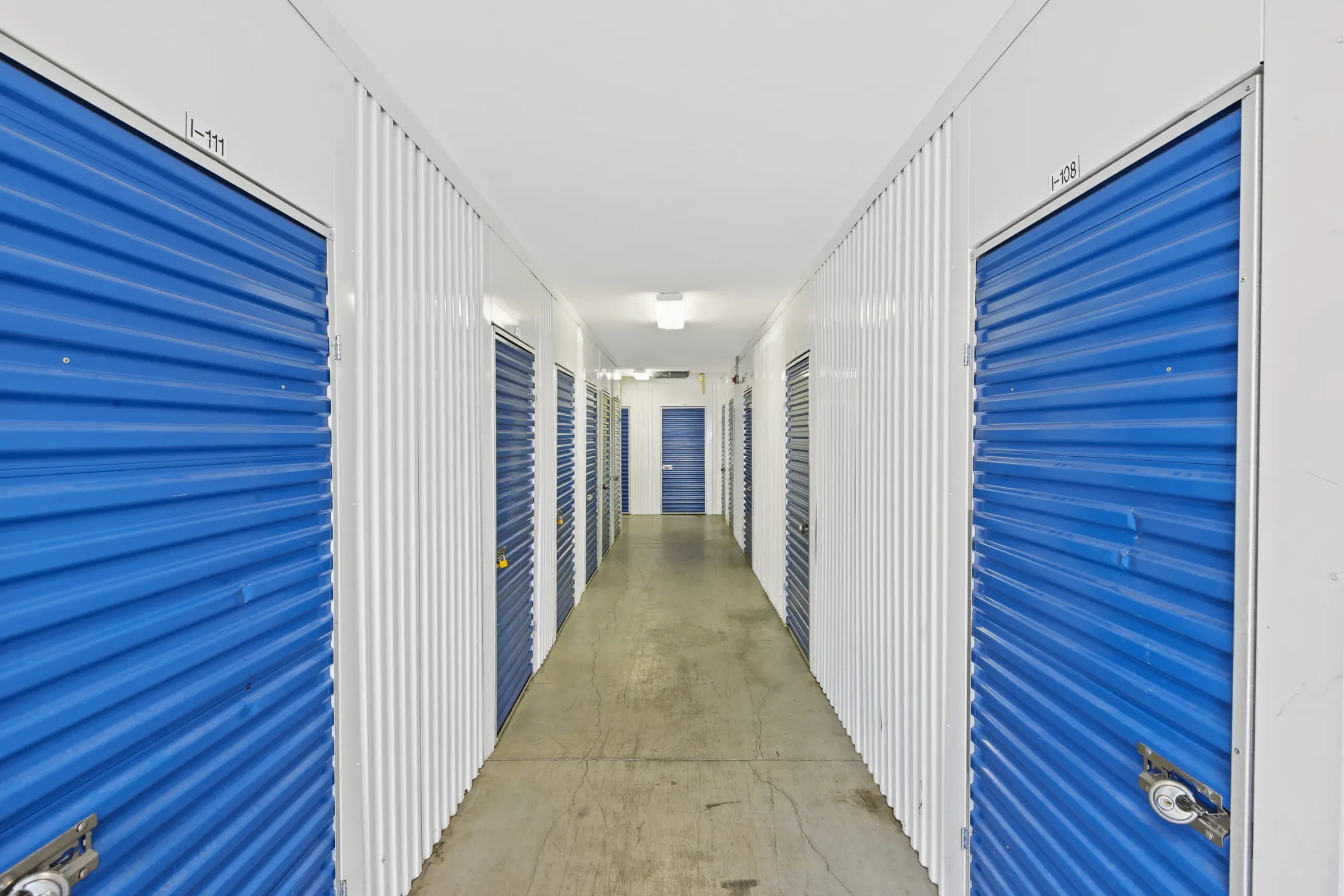 Compass Self Storage indoor storage units with blue doors.