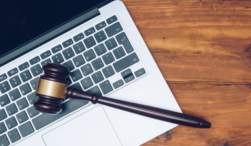 Gavel laying across a laptop keyboard.