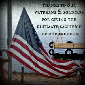 Figure raising an American with the phrase, "Thanks to our veterans and soldiers for giving the ultimate sacrifice for our freedom."