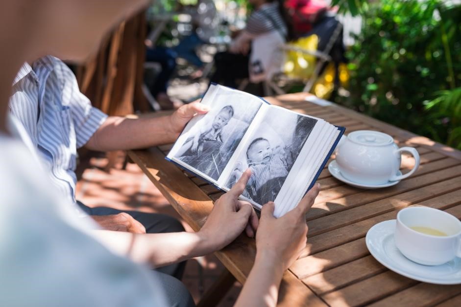 Couple looking at a baby photo album.