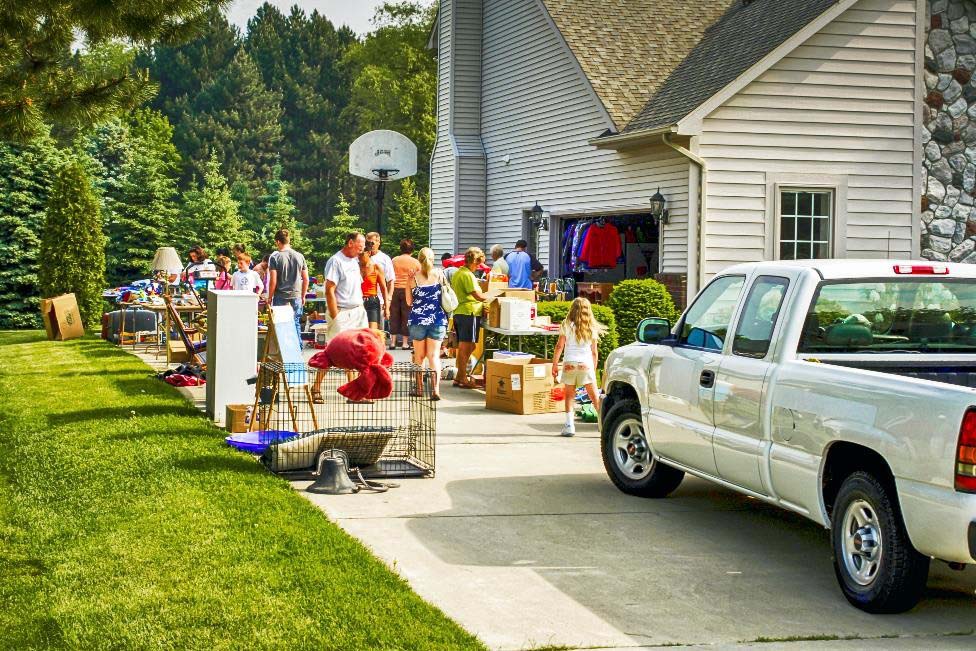 Group of people shopping at a garage sale.