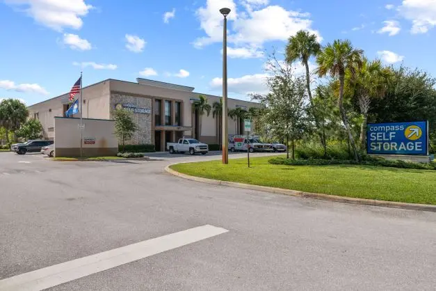 Compass Self Storage facility with a sign near the front of the building.
