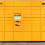 a big yellow Amazon Locker with multiple locker spaces for packages