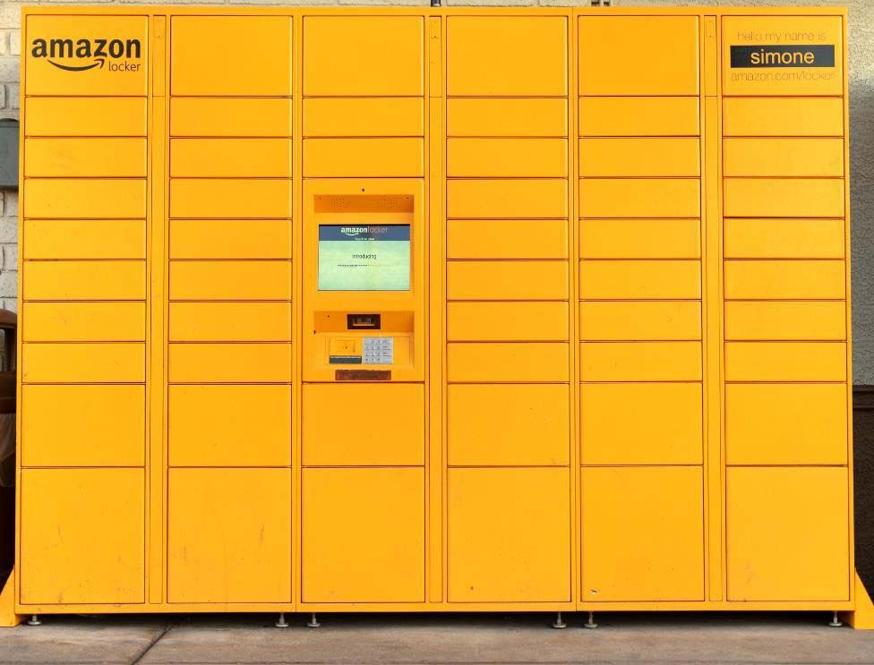 a big yellow Amazon Locker with multiple locker spaces for packages