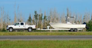 Florida boat owner towing vessel behind truck to Miami boat storage space