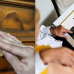 Hand wiping dust off antique furniture and elderly couple looking at an old photo album