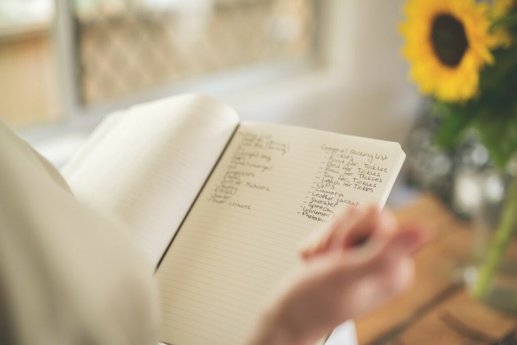 an image of a checklist in a notebook being used by someone planning an event