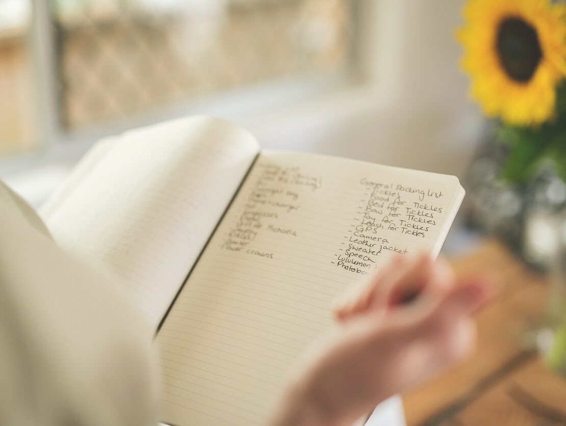 an image of a checklist in a notebook being used by someone planning an event