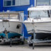 Two boats resting on trailers while in storage for the winter.