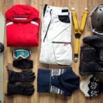 a flat-lay of outdoor winter gear and equipment