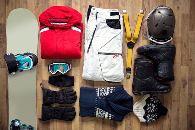 a flat-lay of outdoor winter gear and equipment