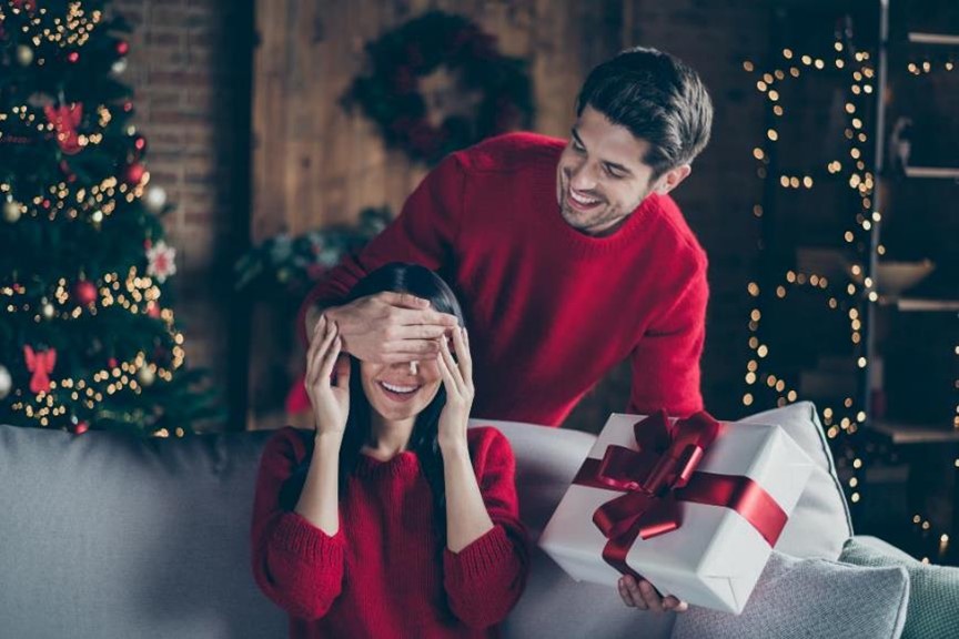 Couple opening up holiday gifts