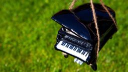 A model piano held by strings