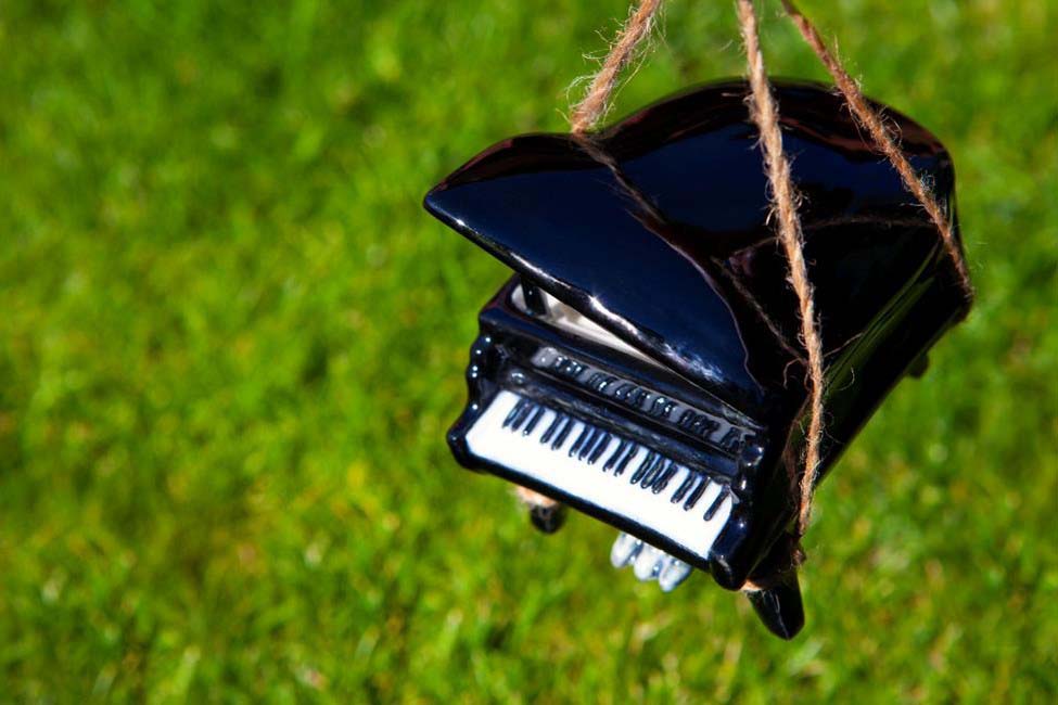 A model piano held by strings