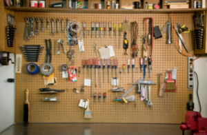 A set of organized tools on the side of the garage