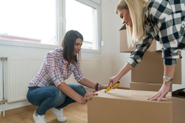 Two college students storing some boxes