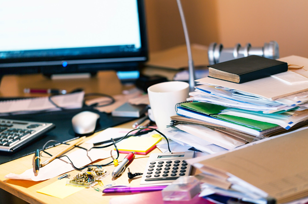 A desk cluttered by items