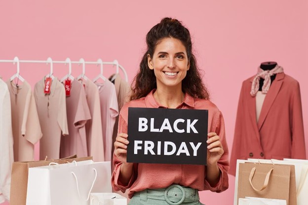 A woman holding a Black Friday sign