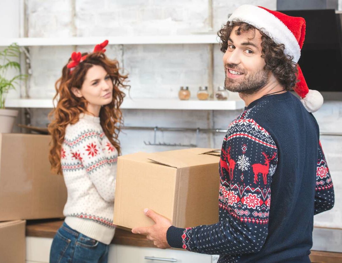 A young couple packs up moving boxes around the holidays