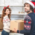 A young couple packs up moving boxes around the holidays