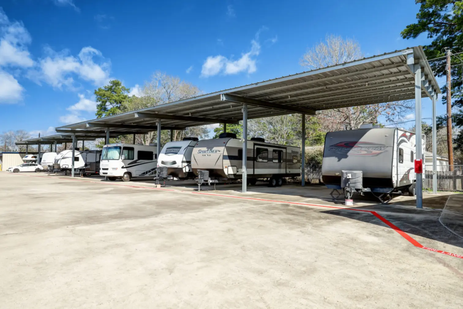Covered RV, boat and car parking at Compass Self Storage in Spring, TX.