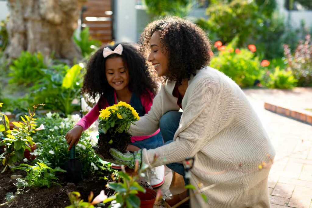 A mother and her daughter gardening together.