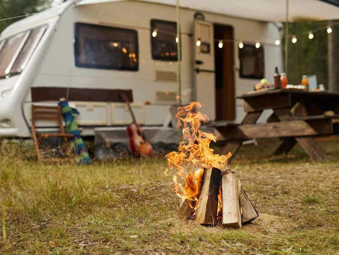 Outdoor camping set, featuring a RV and camp fire