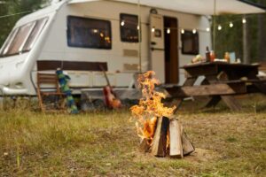 Outdoor camping set, featuring a RV and camp fire