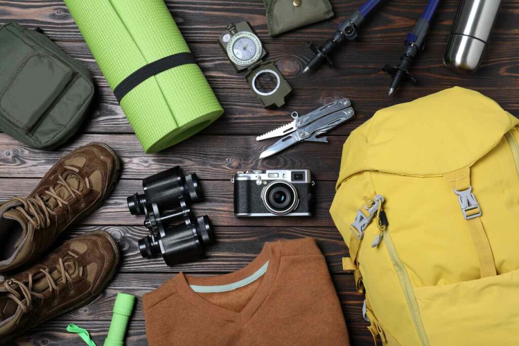 Camping trip item, featuring a camera, backpack, compass, boots and more