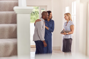 Couple Viewing Potential New Home With Female Real Estate Agent