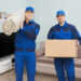 Two Male Movers Standing In House