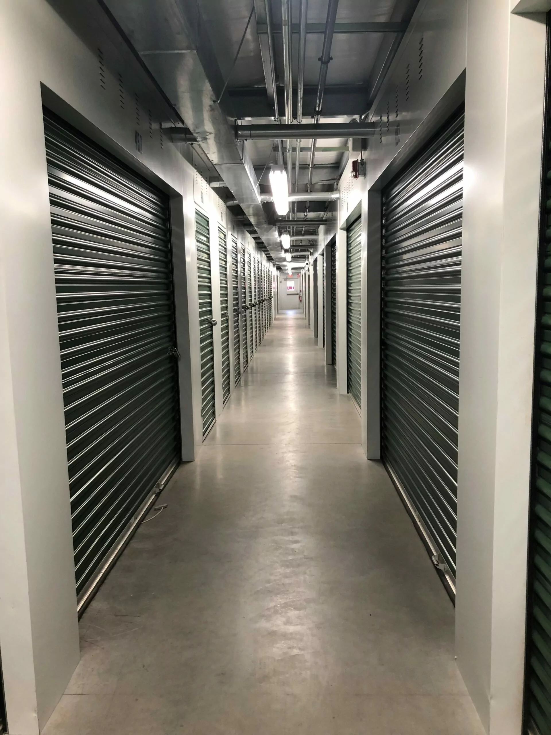 Hallway with indoor self storage units at Compass Self Storage facility.