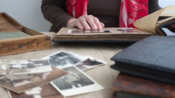 A woman browses through old photos in a family album.