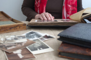 A woman browses through old photos in a family album.