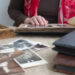 A woman browses through old photos in a family album.