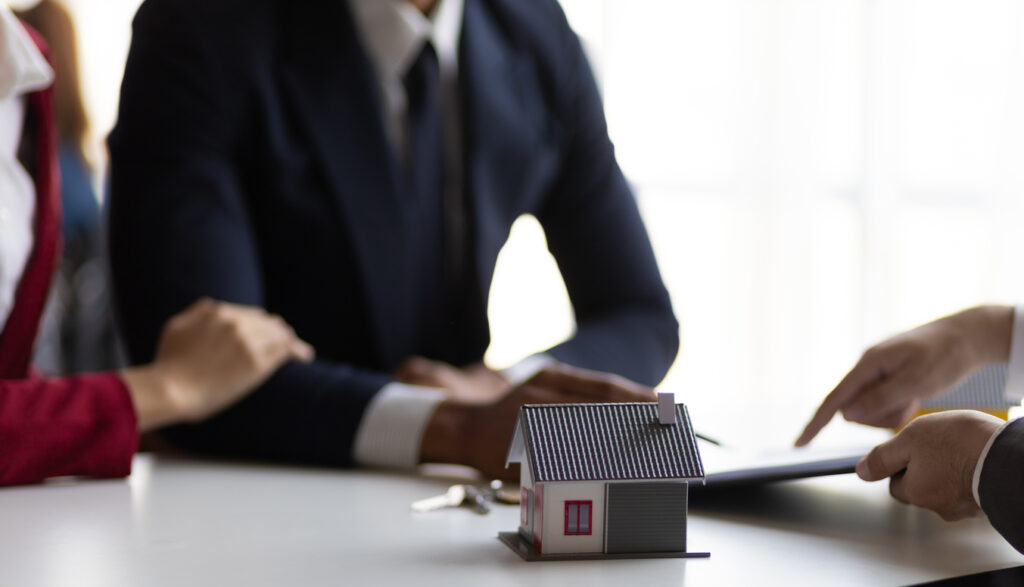 A man and woman talking to an estate sales professional about their loved one’s home. 