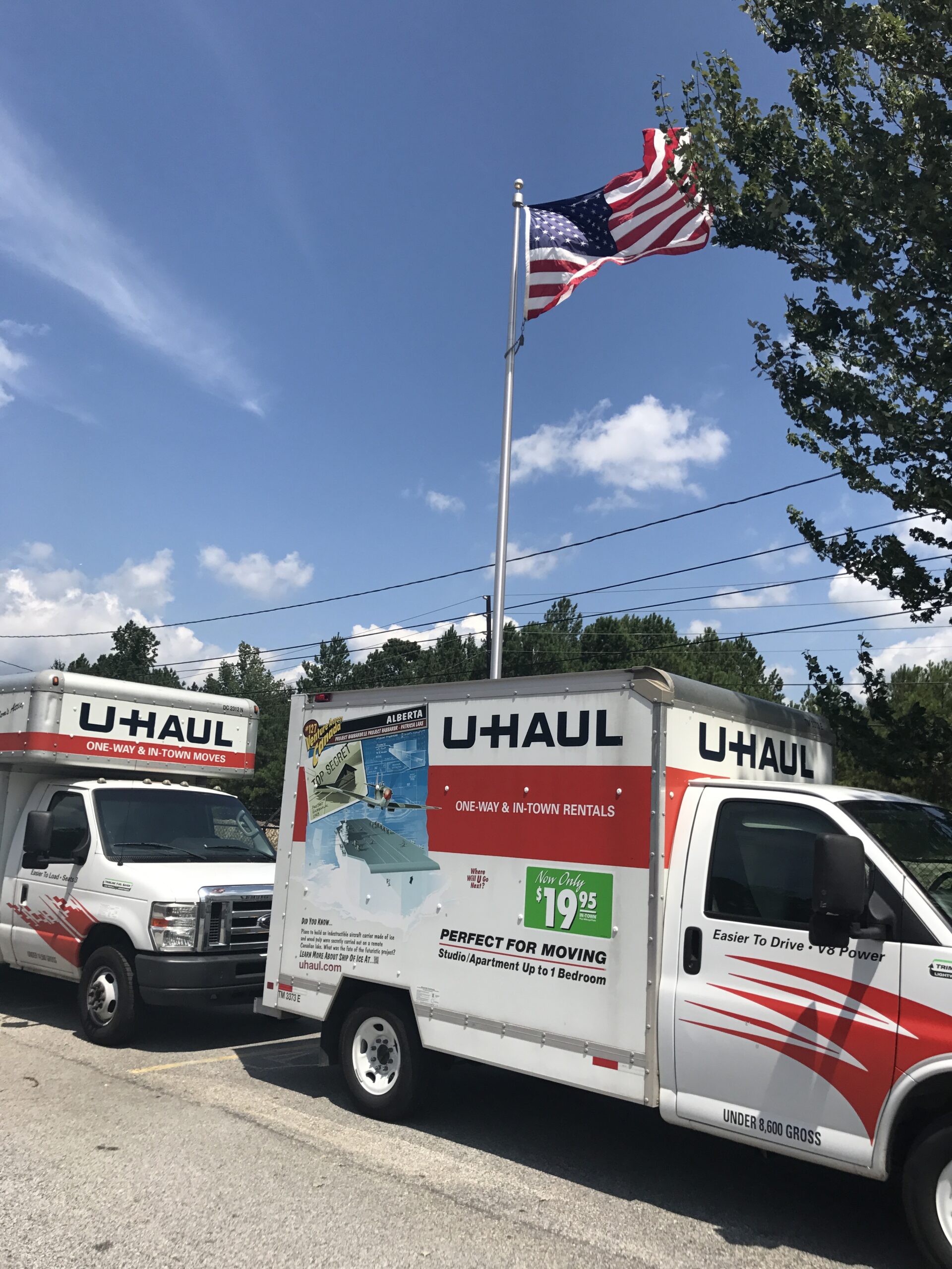 U-Haul box truck with the American flag blowing in the wind.