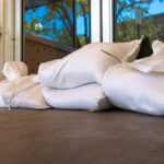 A business with sandbags in front of its doors in preparation for a hurricane.