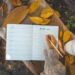 A woman writing down a to-do list as she prepares for the fall.