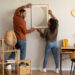 A man and woman decorating their spare room at home.