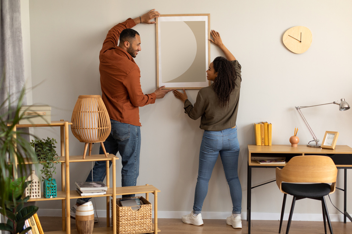 A man and woman decorating their spare room at home.