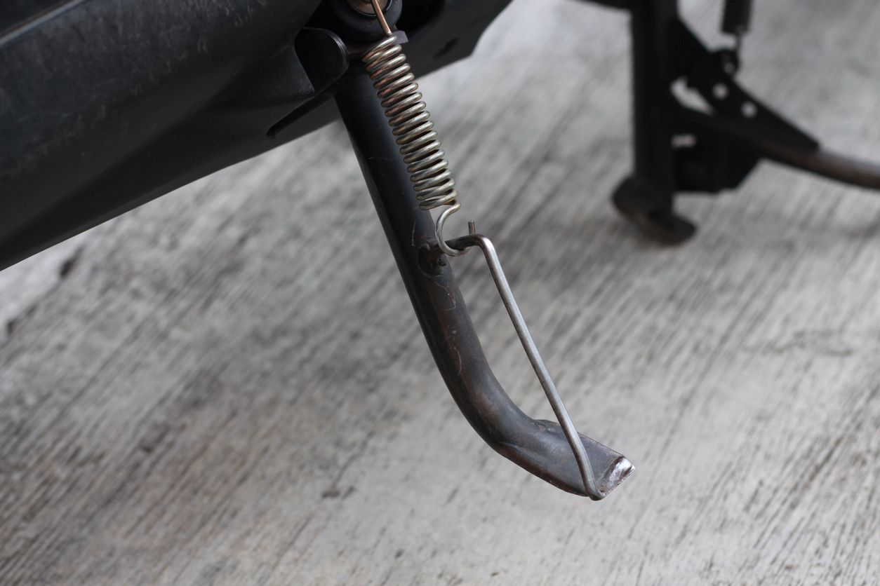 A motorcycle kickstand with a spring.