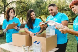 Community volunteers collecting food and supplies at a charity event for disaster relief